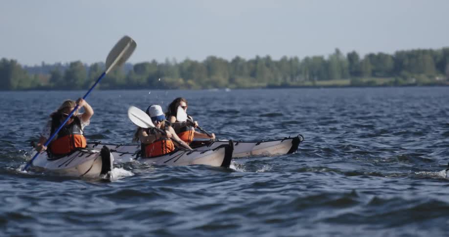 People are racing in canoes