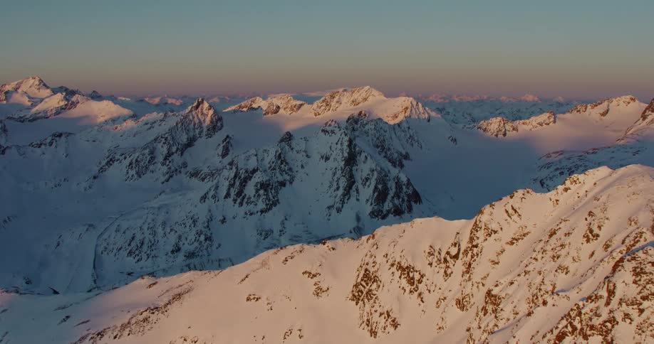 A thick blanket of snow covers a mountain range