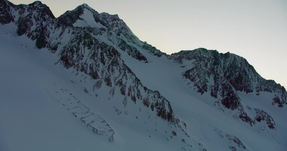 A blanket of snow covers a mountain range