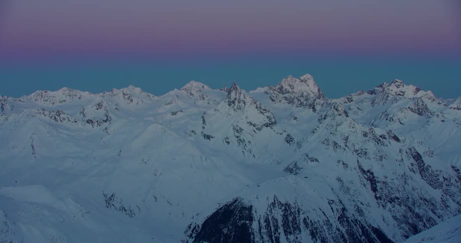 Aerial view of snowy mountain range at dusk