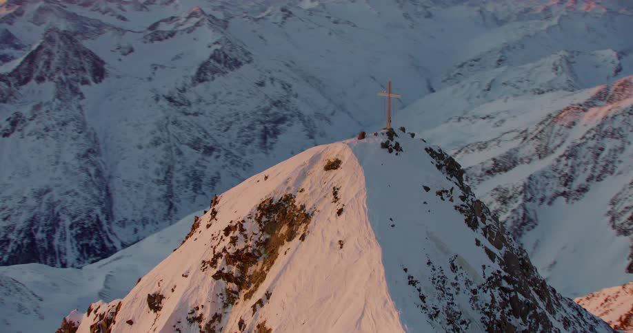 A cross is at the top of the mountain