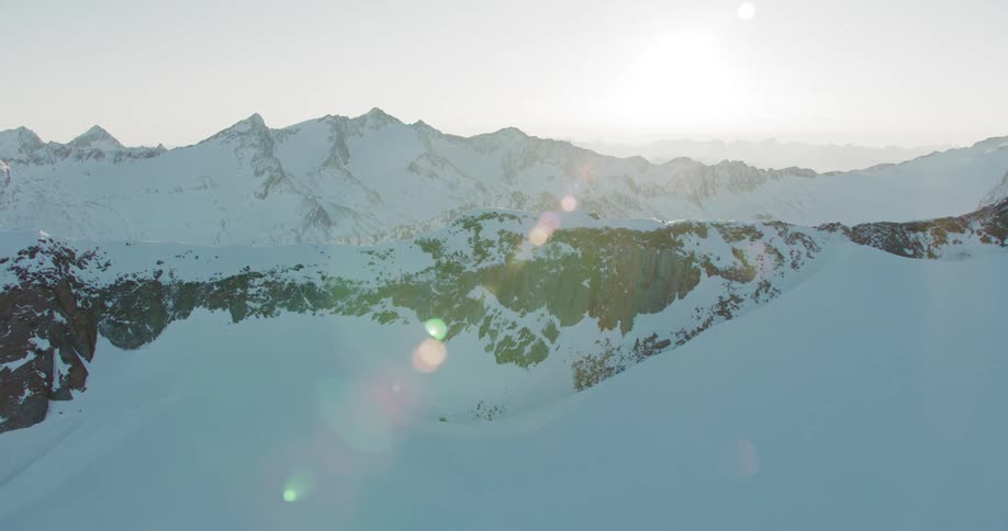 A rocky and mountainous landscape is completely covered with snow