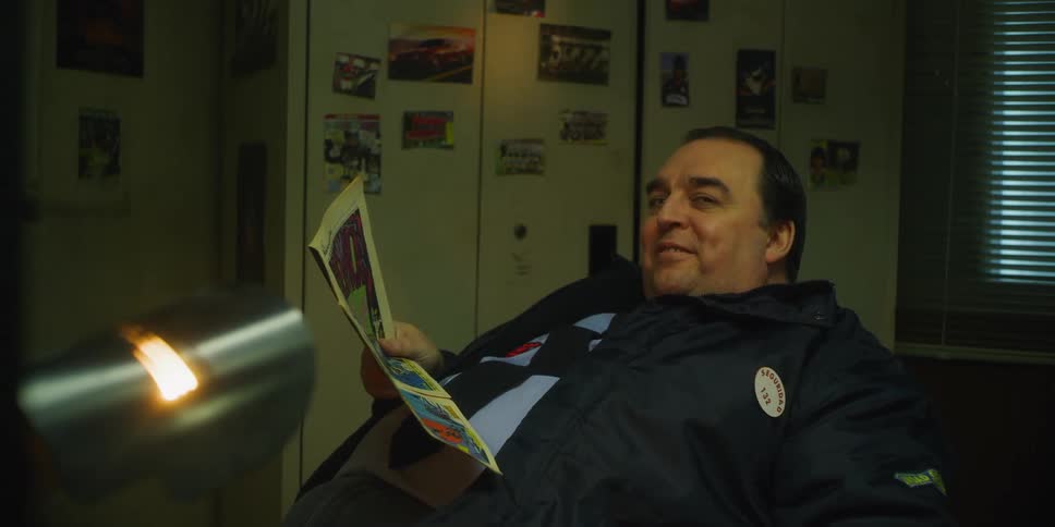 A security guard reads a magazine