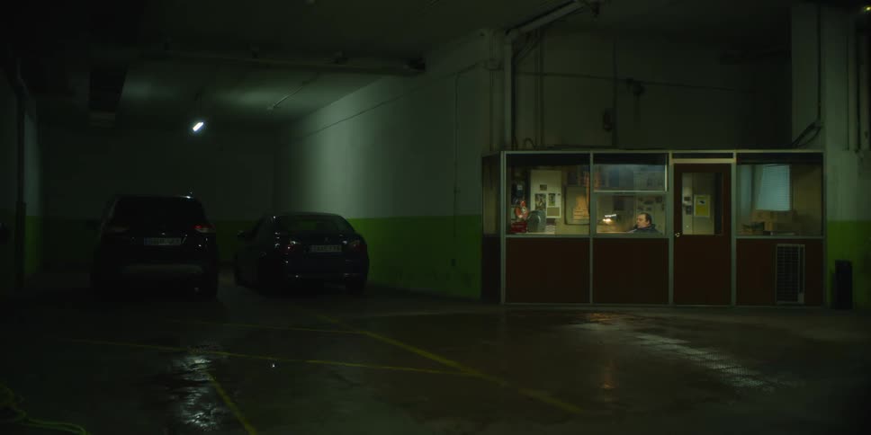 A man sits in the booth in the parking lot