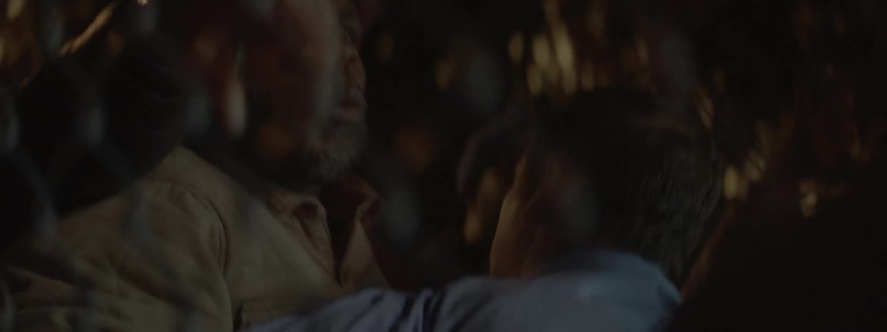 A yelling man is held back by police
