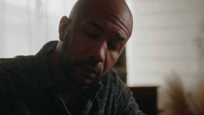 The view is of an older man inside of his home