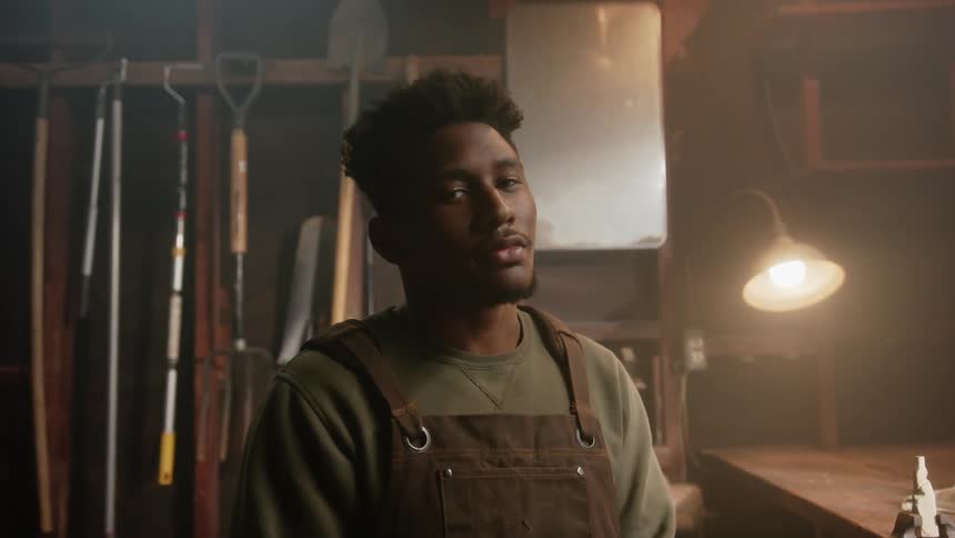 The view is of a young black man as he is smiling at the camera
