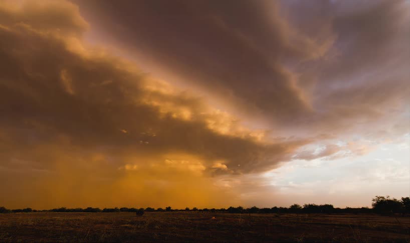 A storm is forming in the distance of this field
