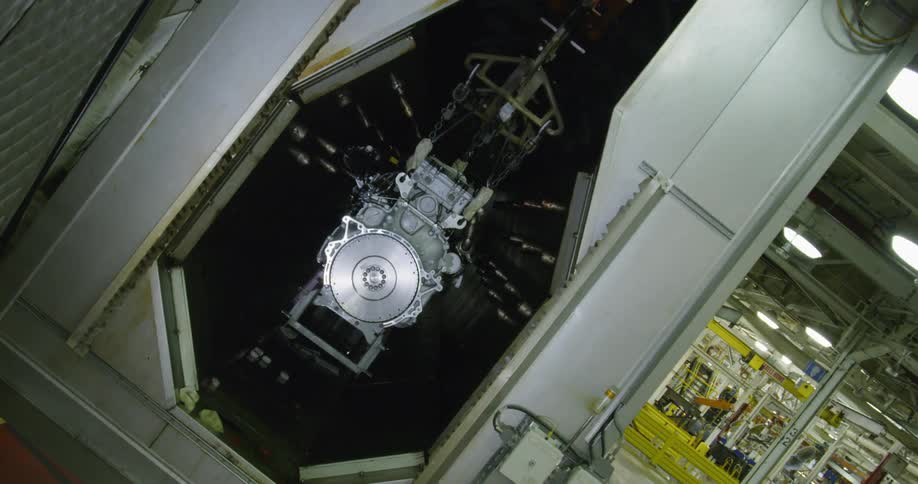 An engine is sitting in an industrial machine inside a factory