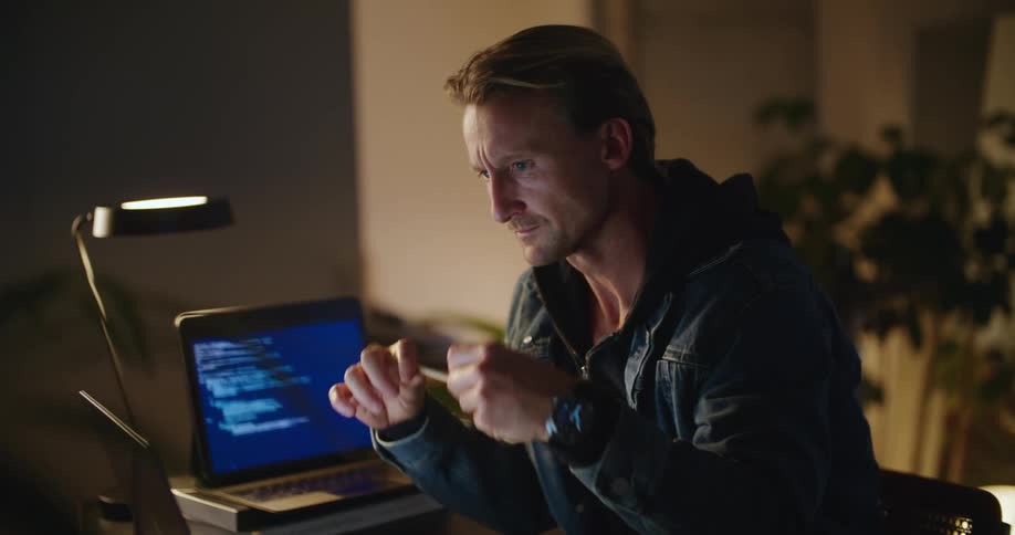 A man is typing on his laptop