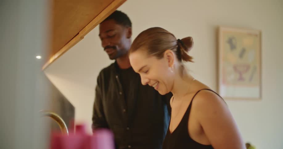 A couple kiss in the kitchen
