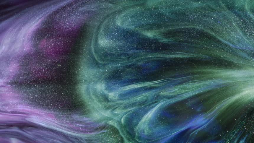 A sparkling wave of green and purple glitter expands across the screen and glows