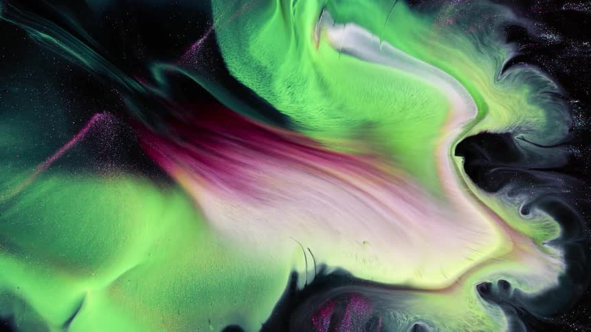 Yellow green and purpole cloud glows and expands like a starburst