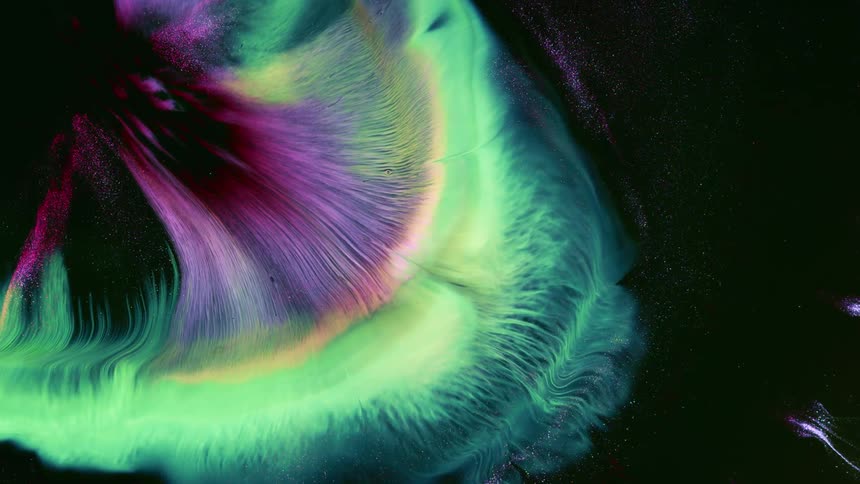 A wave of neon green yellow and purple explodes in the sky