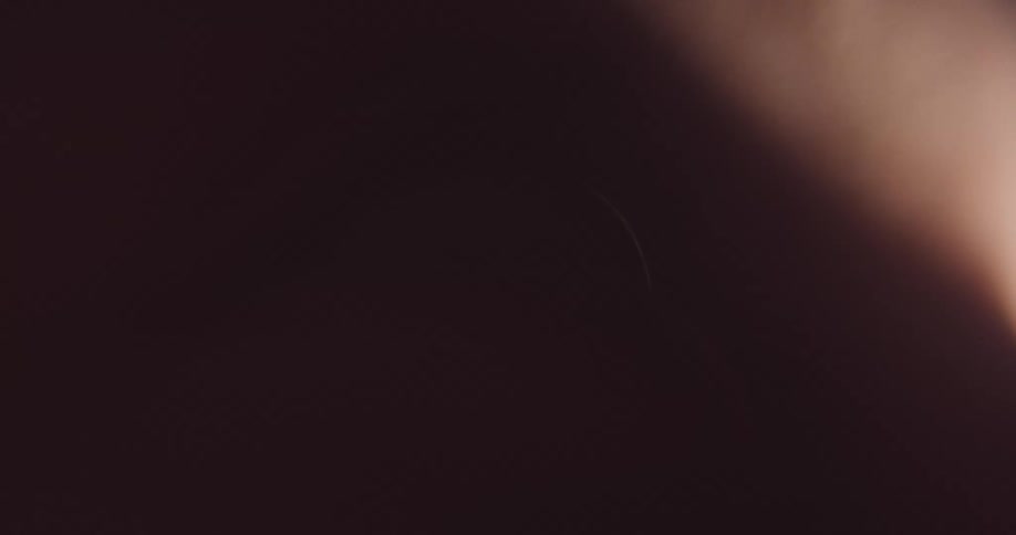 An extreme close up of a persons eye ball blinking with a shadow across it