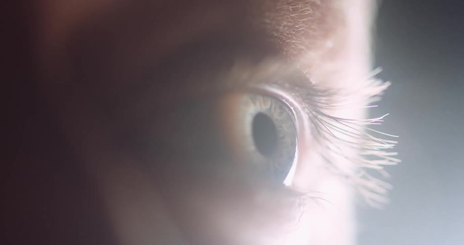 Light shines on a person eye and illuminates their eyelashes