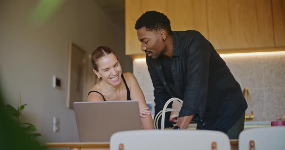 Man and woman are talking and looking at a laptop