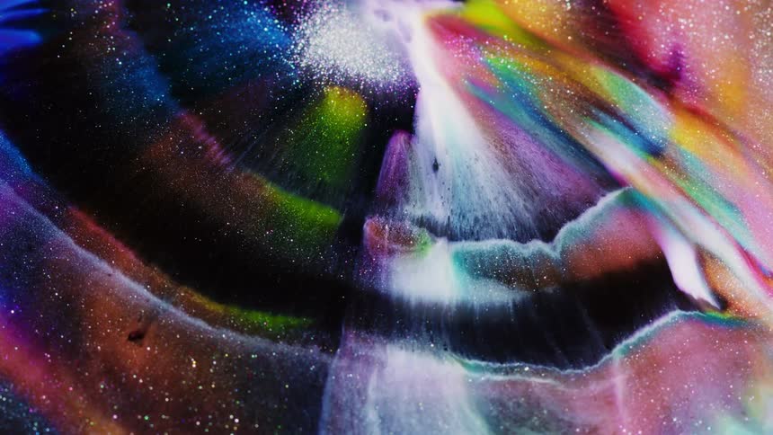 Bands of colored stripes move outward twinkling as they float away into the darkness
