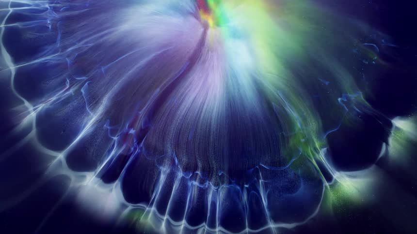Glowing colors inside an orb expand and spread with organic white wisps