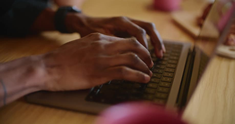A close up of a persons finger typing on a laptop keyboard