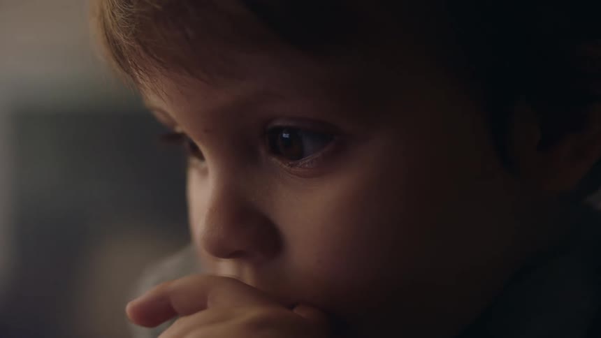 Close up of toddler boy staring down