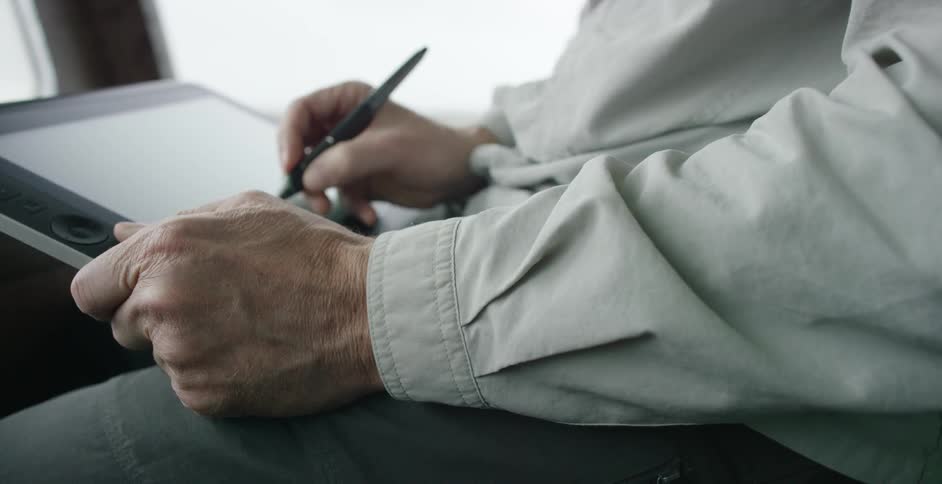 Man draws something with a stylus on a screen
