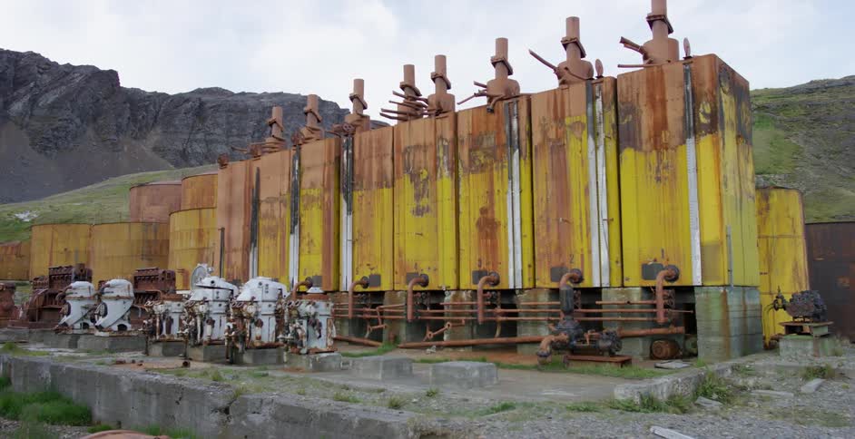 Large industrial type machinery sits  below some mountains