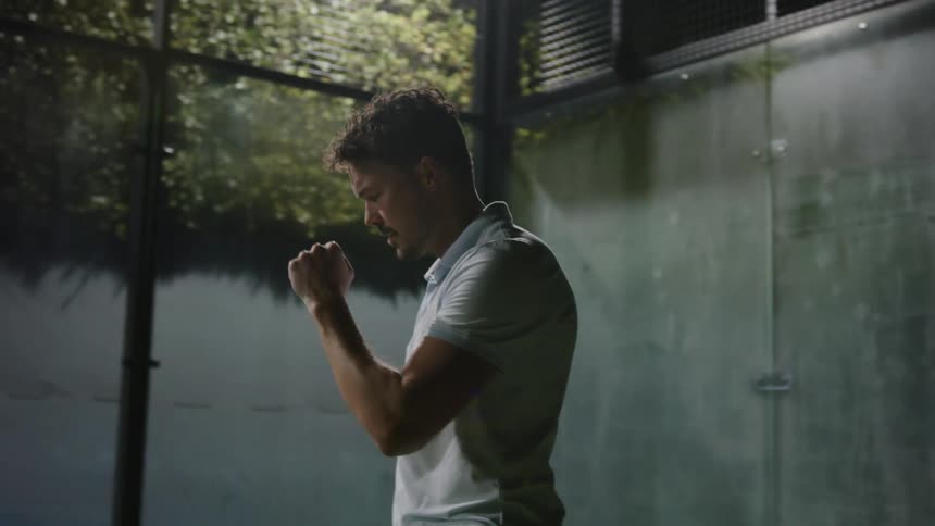 A man pumps his fist in celebration after swinging his paddle during a pickle ball match