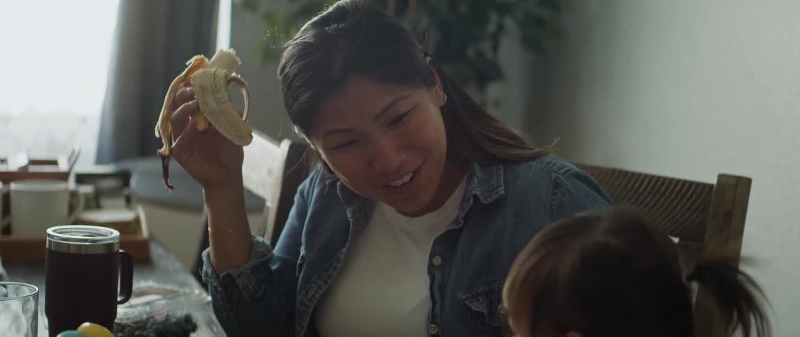 Parents sitting at the dining table with their daughter eating breakfast