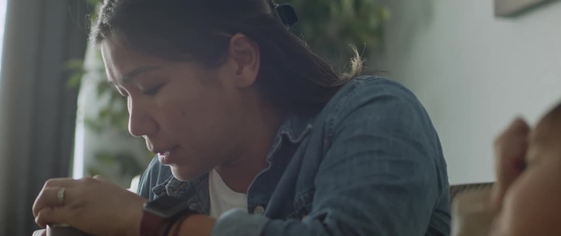 A toddler sits at the kitchen table with her mom
