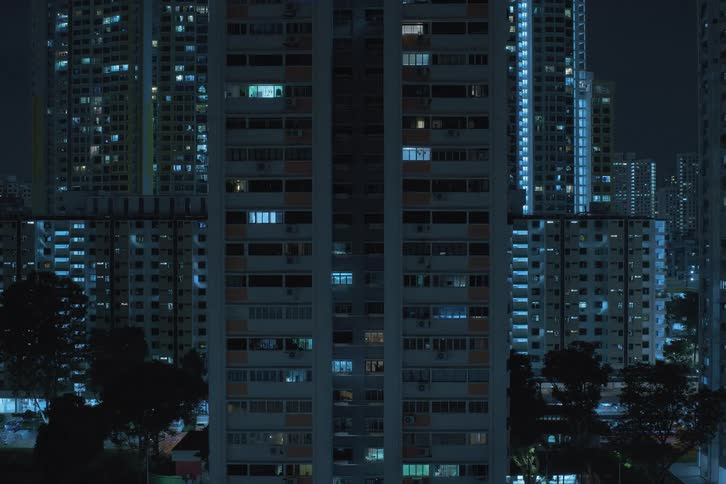 The view is of the downtown area in the night time as window lights turn off