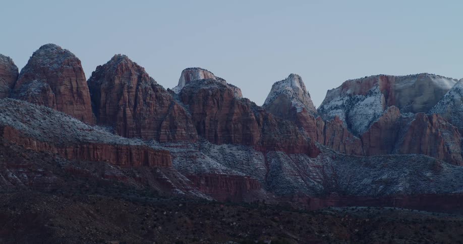 Landscape of snowy rugged mountains at dusk