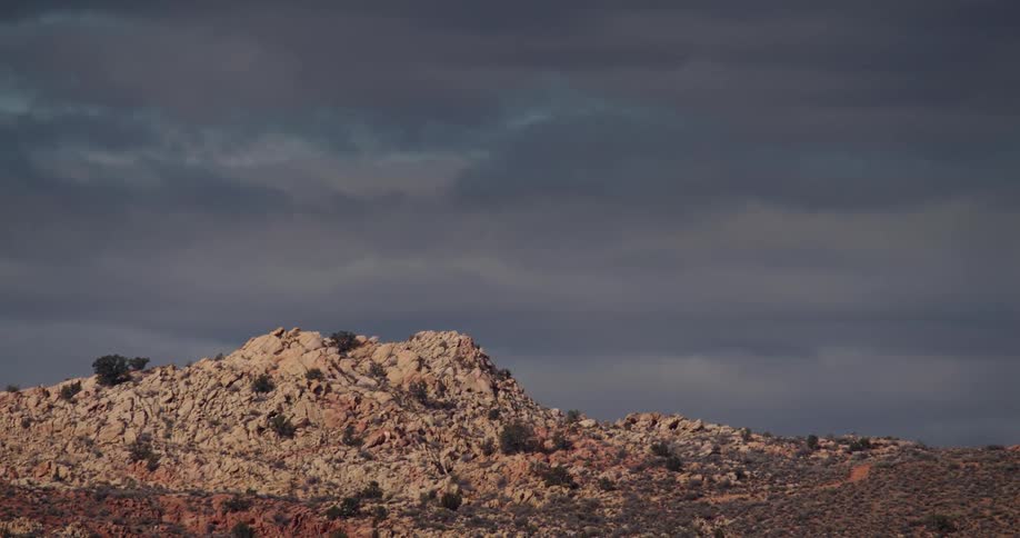Landscape of rocky hill under clouds