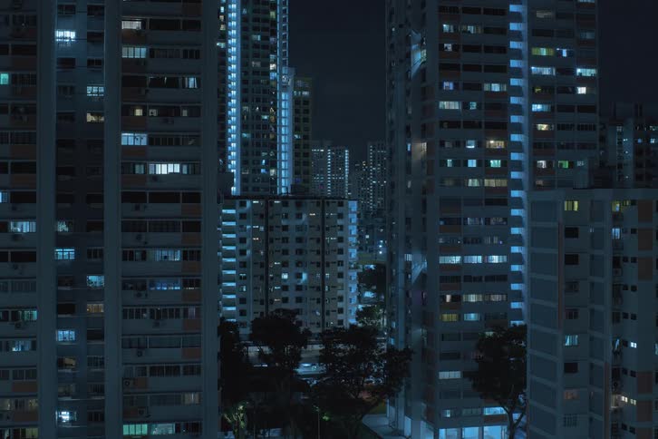 Time lapse of office lights turning off in a city skyline
