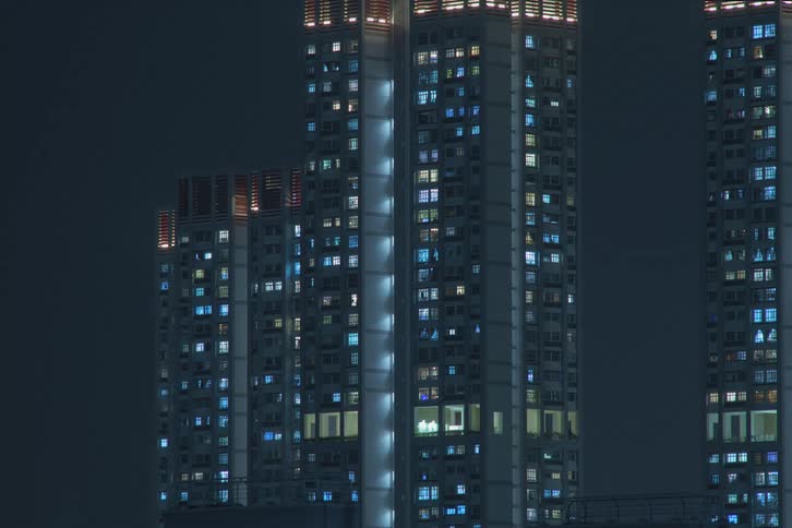 Time lapse of lights turning on in high rise apartment building at night