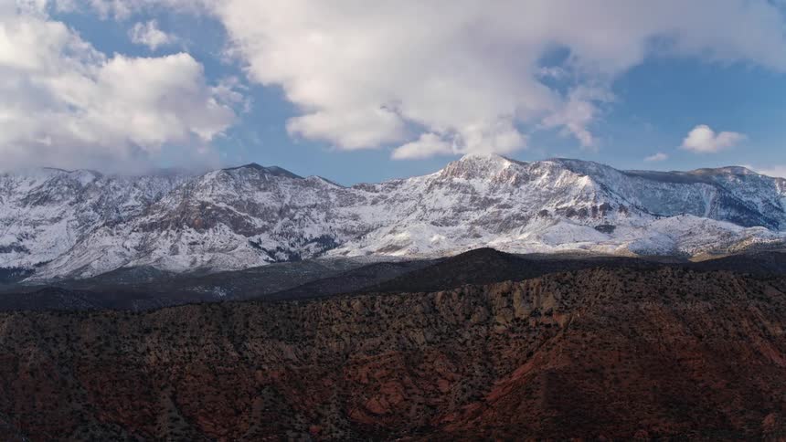 Snow covers the upper portions of a Utah mountain range