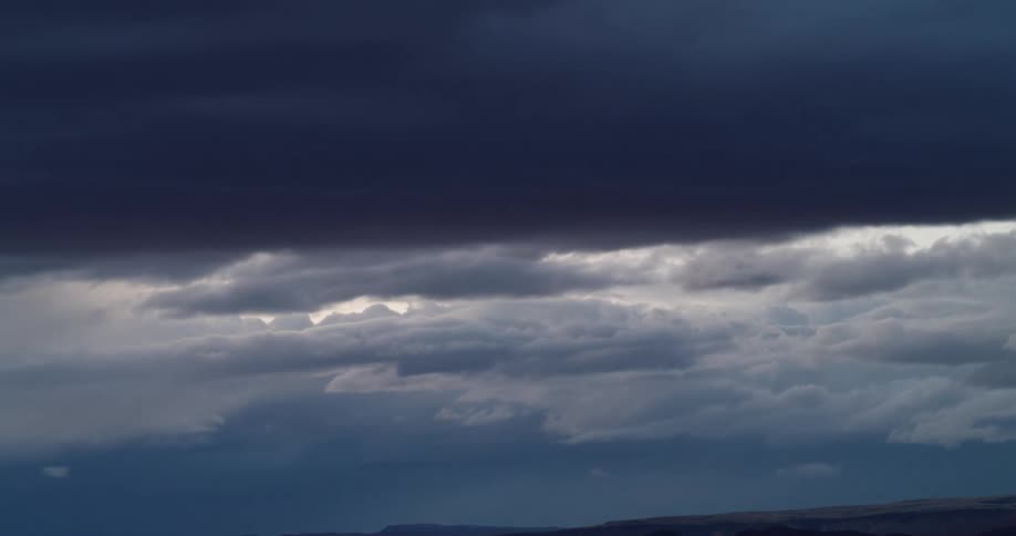 Time lapse of storm clouds forming in the sky as night approaches