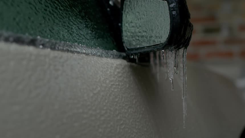 A thick layer of ice covers the outside of a vehicle