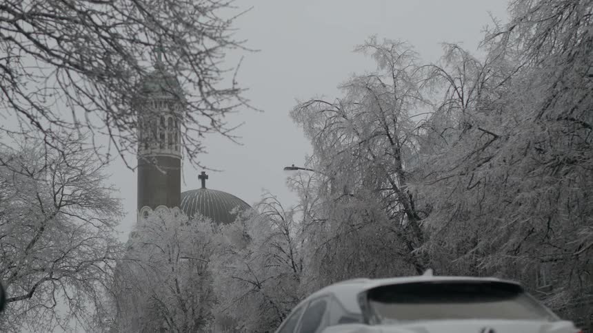 Cars drive towards the church