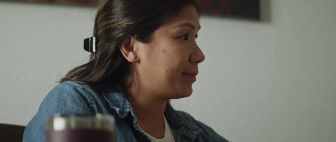 Close up of the face of a woman sitting in the dining room at home