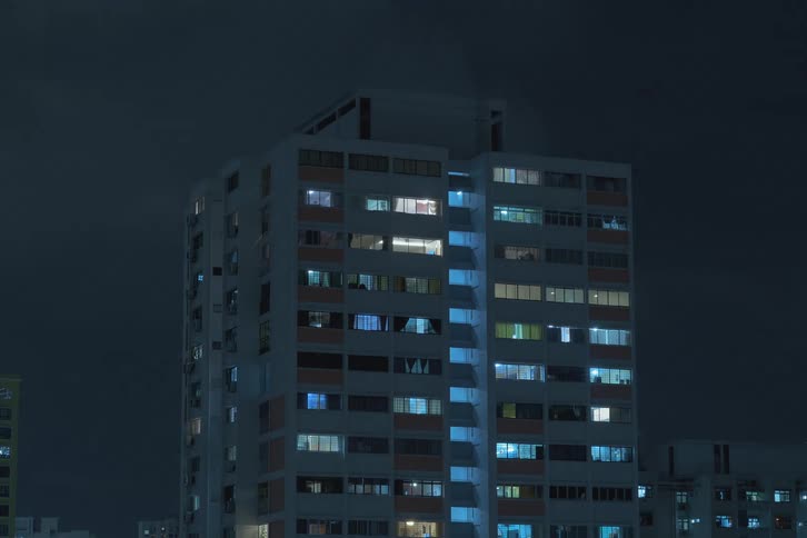 Time lapse of lights turning on in a high rise condo at night