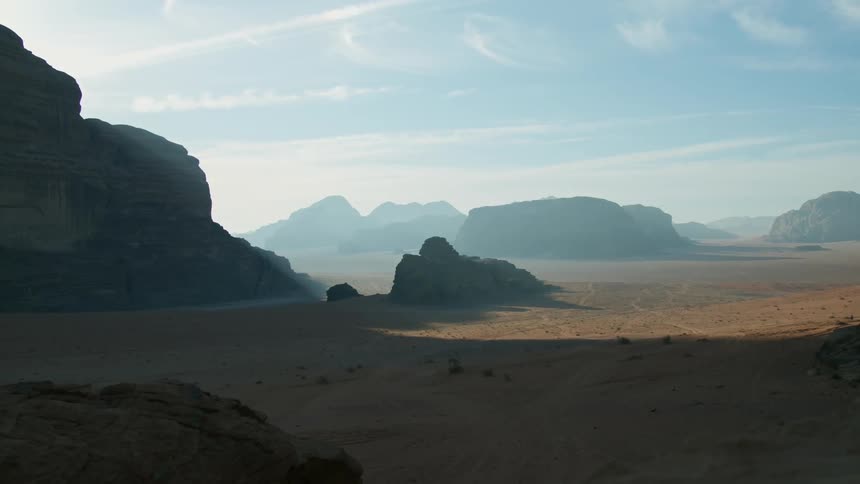 Dense fog covers low mountains dotting arid desert