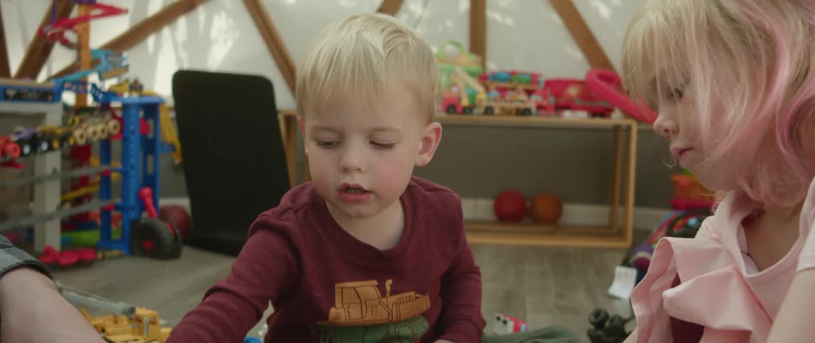 Toddlers are playing with there toys inside of there home