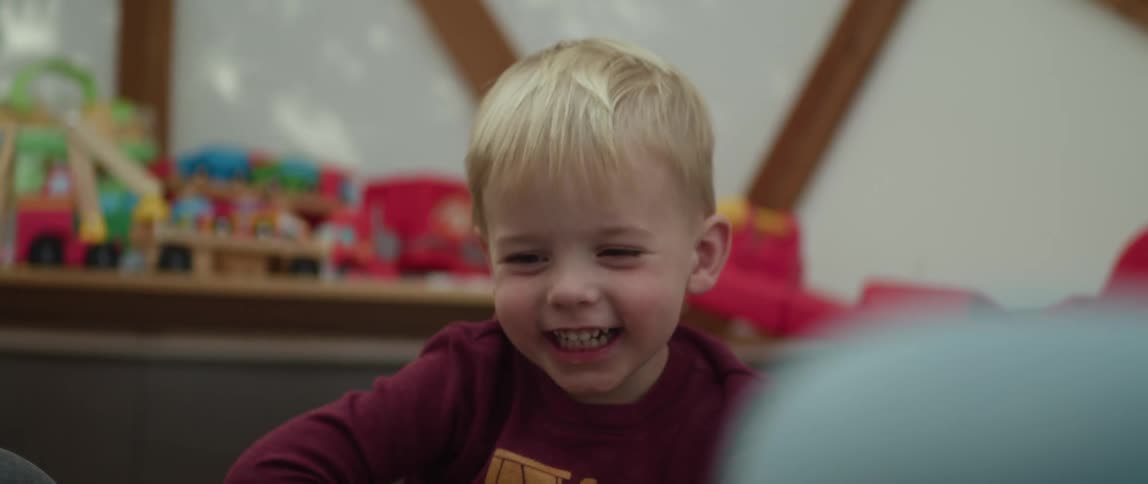 A child laughing and playing in a room