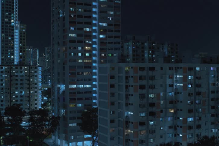 High rise condominiums with flashing lights turning off during night