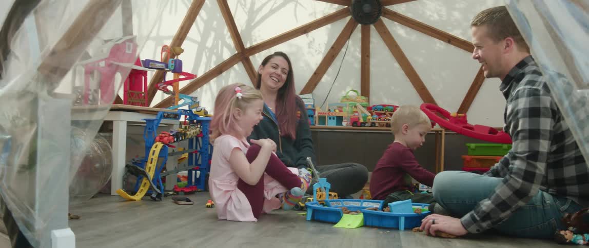 Family is playing together with their toys in the day time