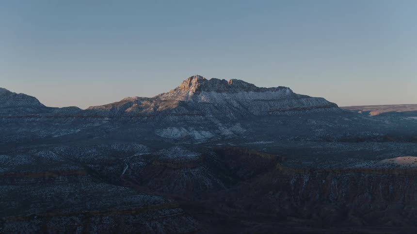 Layers of canyons, mesas and desert mountains seen at dawn