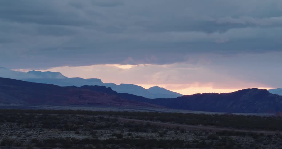 Panoramic view of a distant mountain range in the badlands at dusk