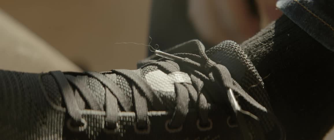 A person is tying their sneakers