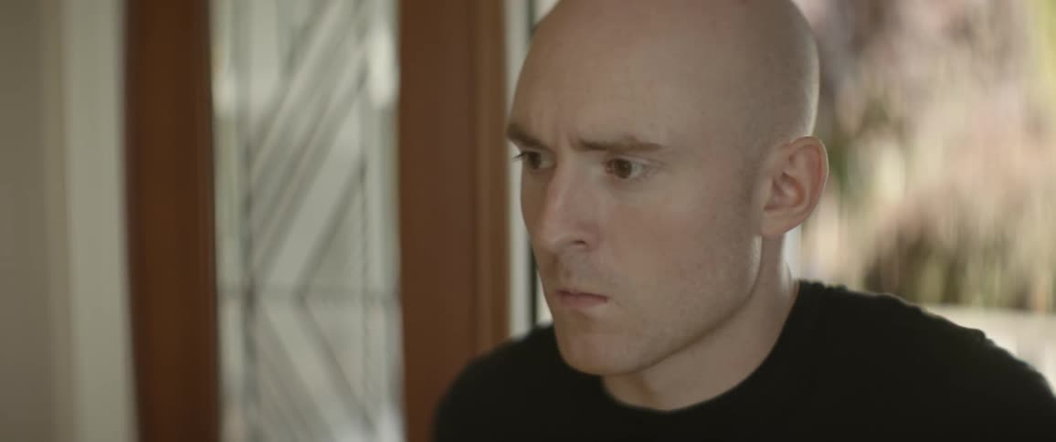 Man opens door and takes a step in the house